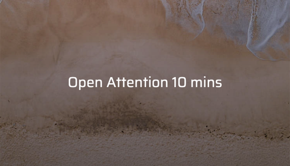Ocean tide on a sandy beach with the text "Open Attention 10 mins"