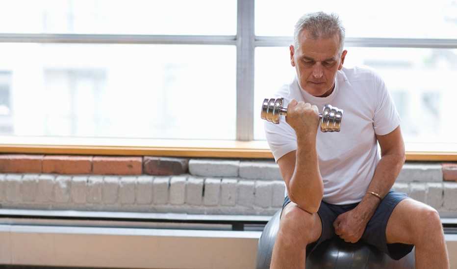 A man doing an arm curl with a dumbbell