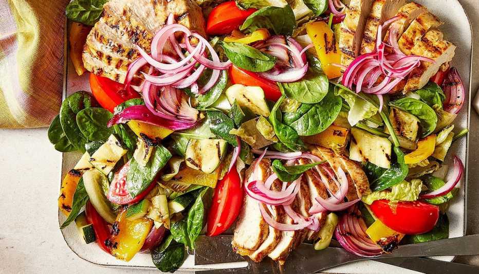 A close-up view of a high-protein grilled chicken salad on a plate