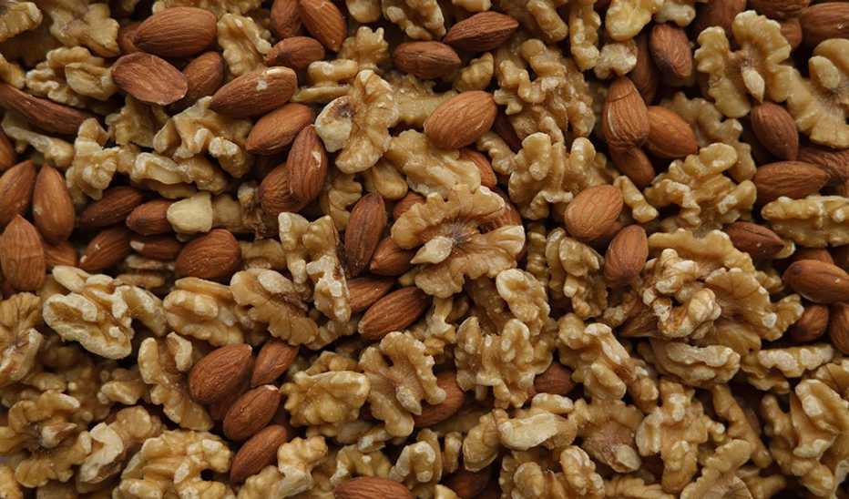 An overhead view of almonds and walnuts