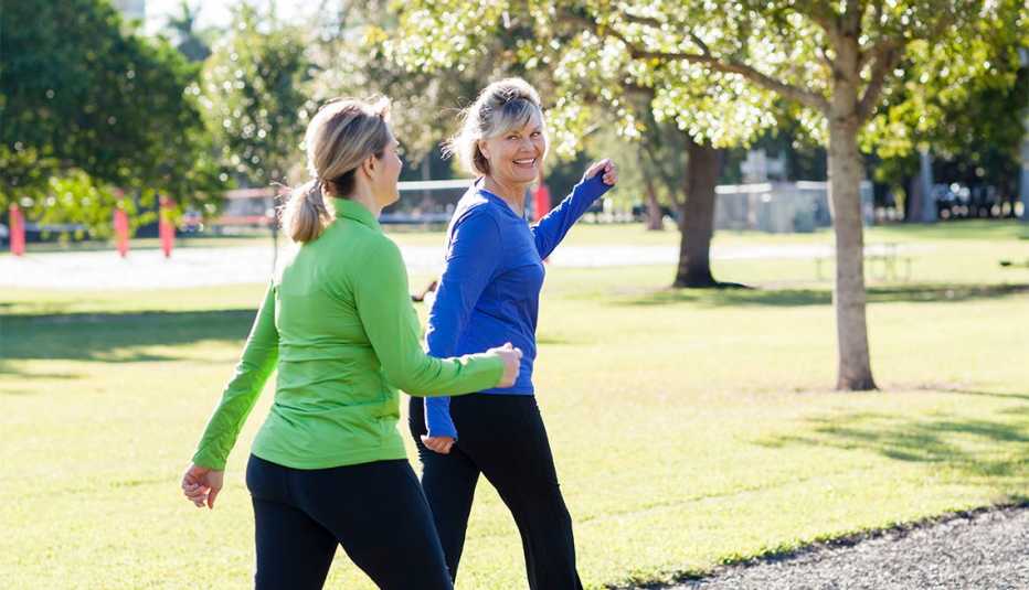 Two women walking together in a park