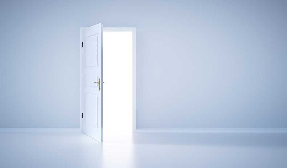 Light shining from an open door in an empty room