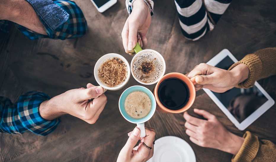 A high-angle view of people drinking various types of coffee together