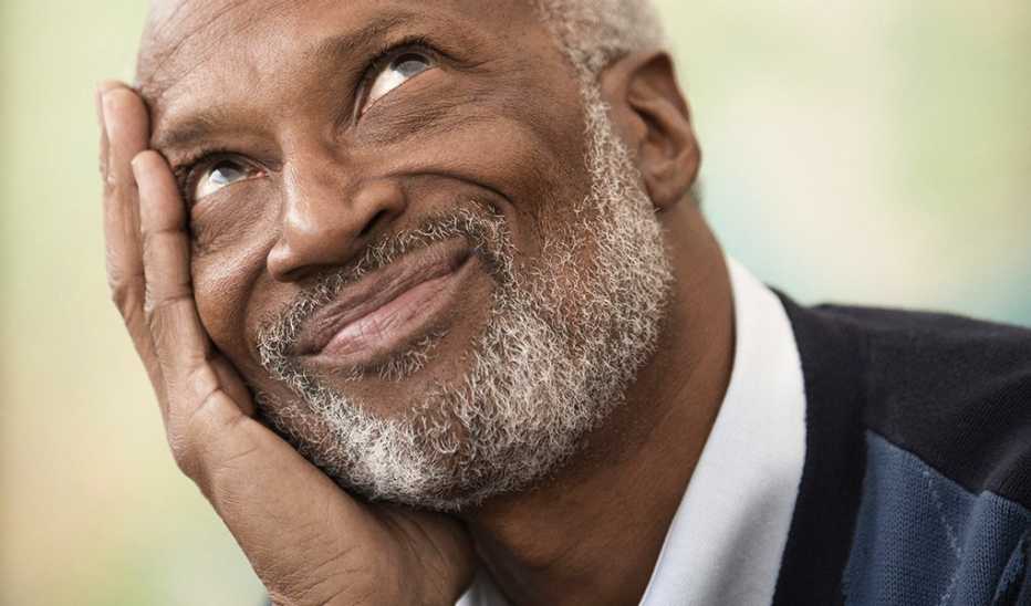An up-close view of a man with his head in his hand
