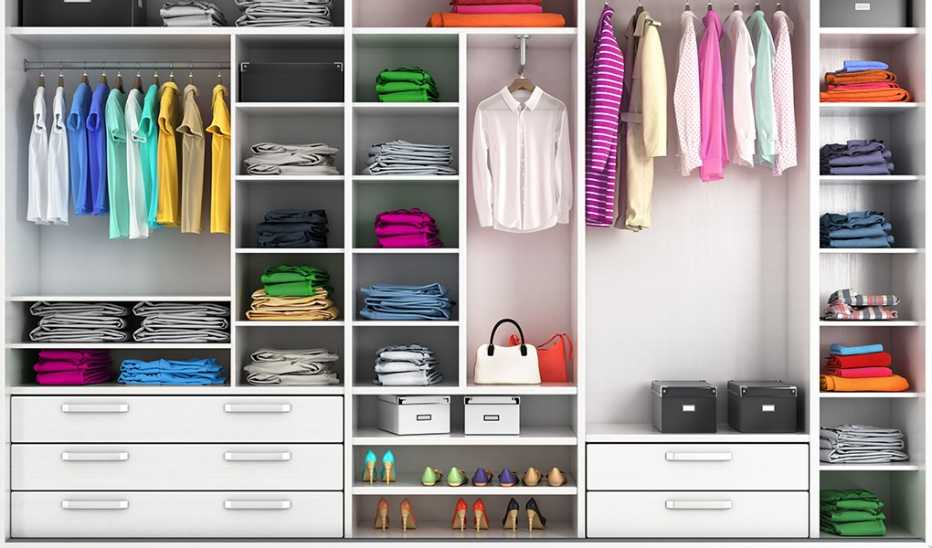 An organized clothing closet with many shelves and drawers