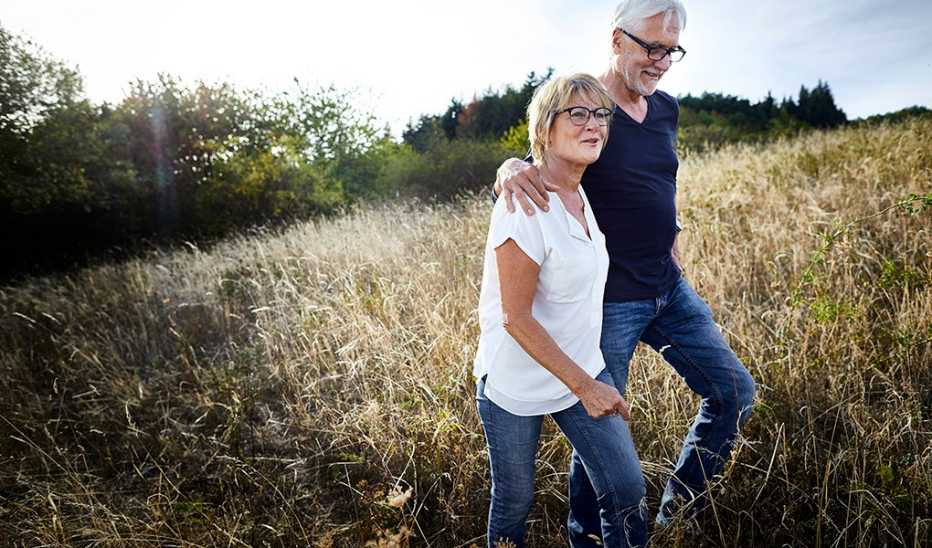 A man and woman walking together in a field