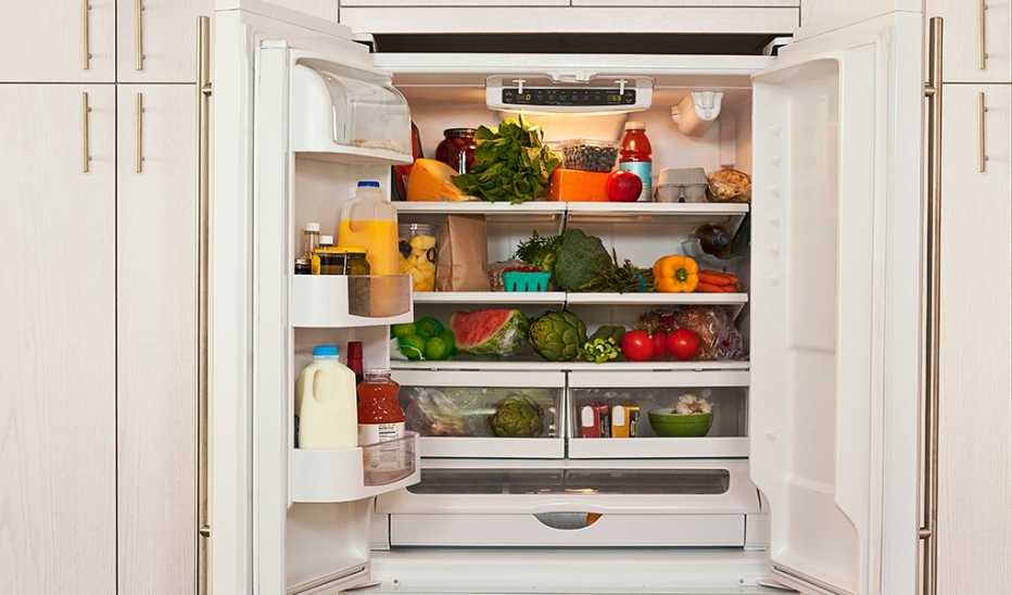 An open refrigerator filled with healthy food