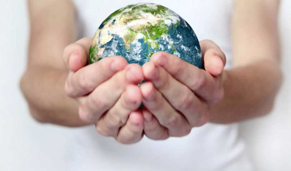 A close-up of hands holding Earth