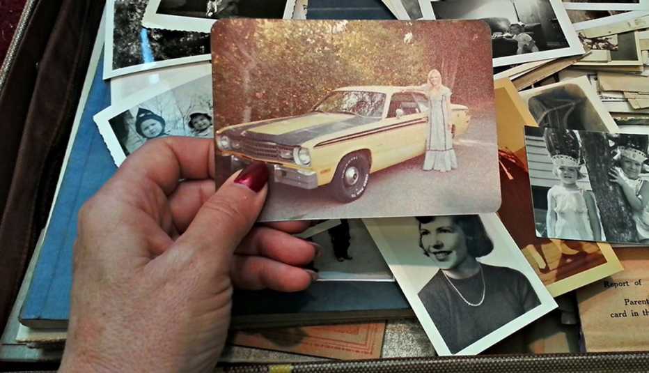 A hand holding an old photograph