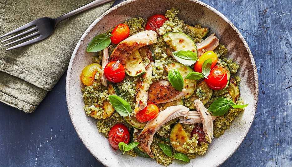 A close-up view of a pesto chicken quinoa bowl