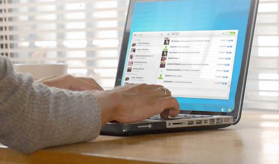 A person using a laptop on a desk