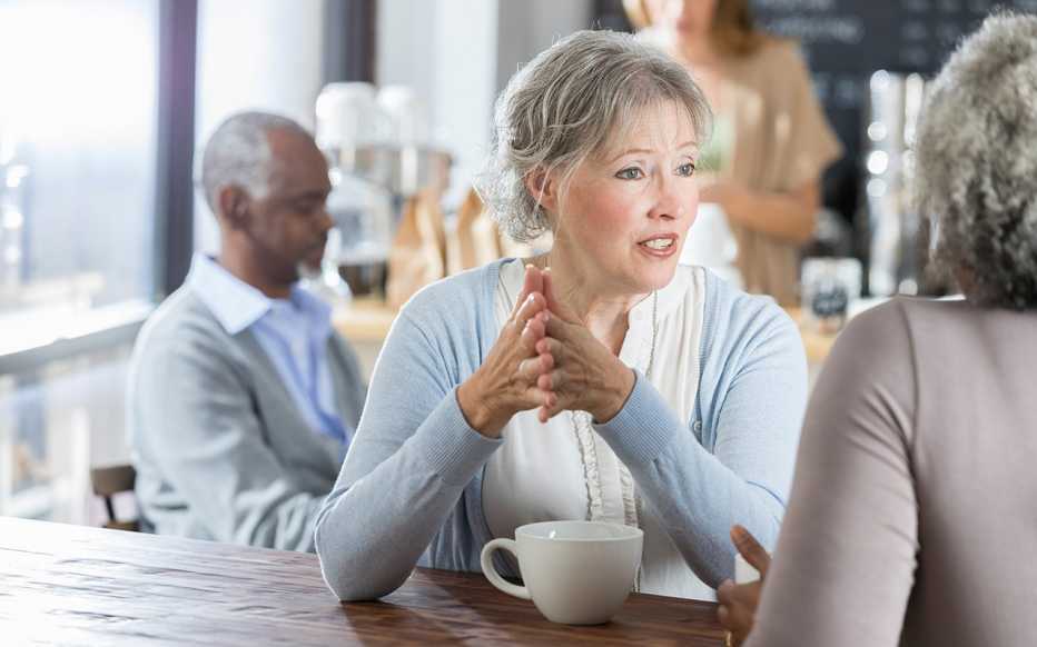 Two women talking together at a coffee shop