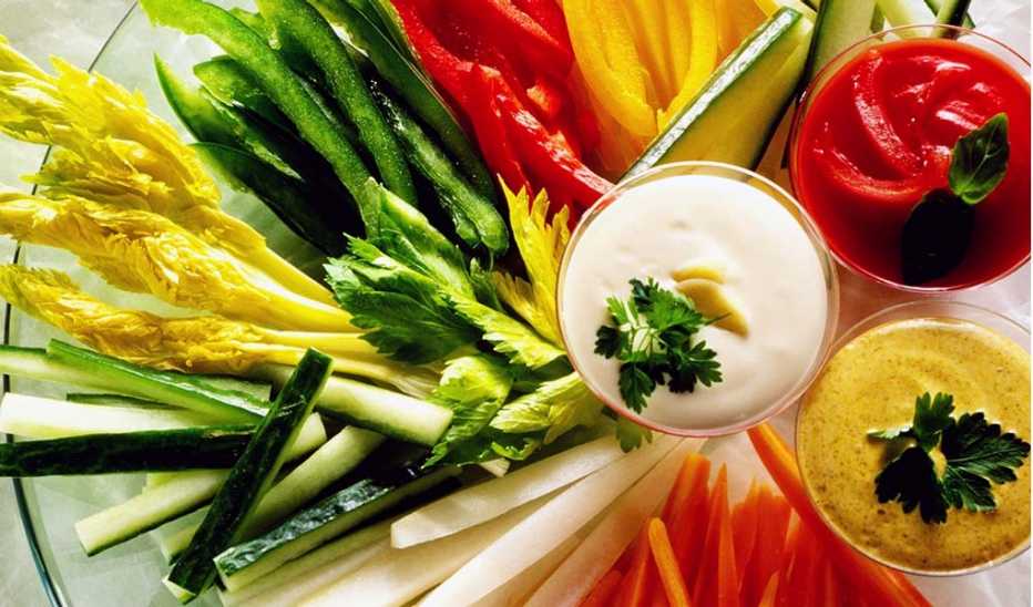 Crudités and three dips on a glass plate