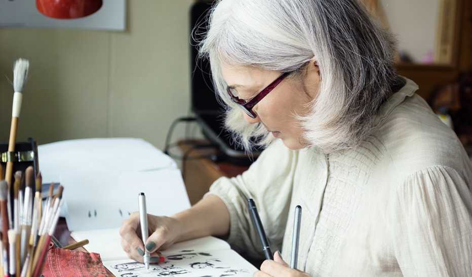 A female artist drawing in a sketchbook
