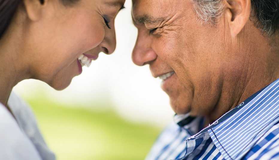 An up-close view of a man and woman with their foreheads touching each other