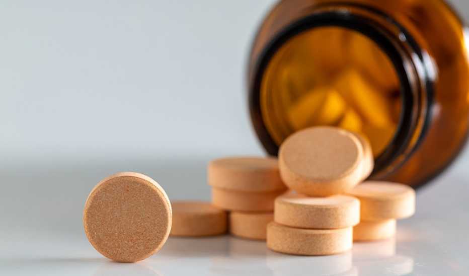 A close-up of vitamin pills on a white background