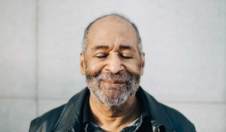 A portrait shot of a man with his eyes closed