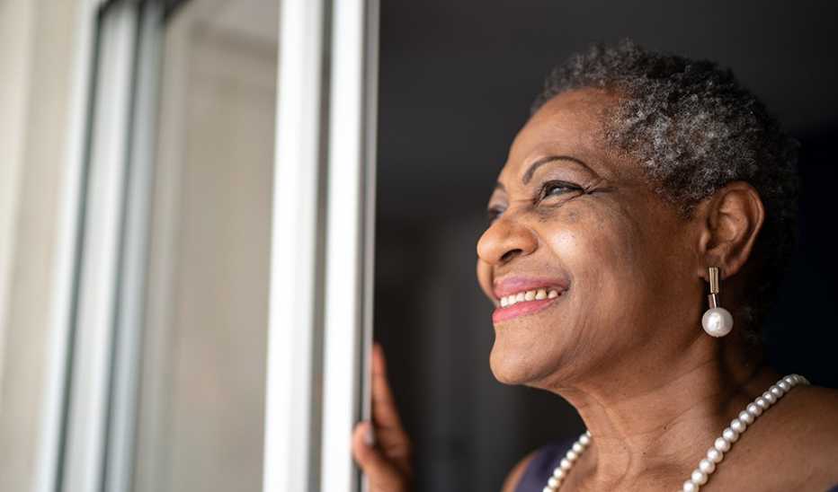 A woman smiling and looking at the view outside