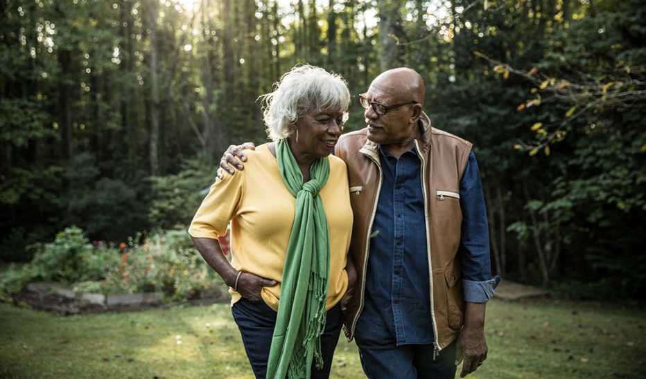 A man and woman walking together in the woods
