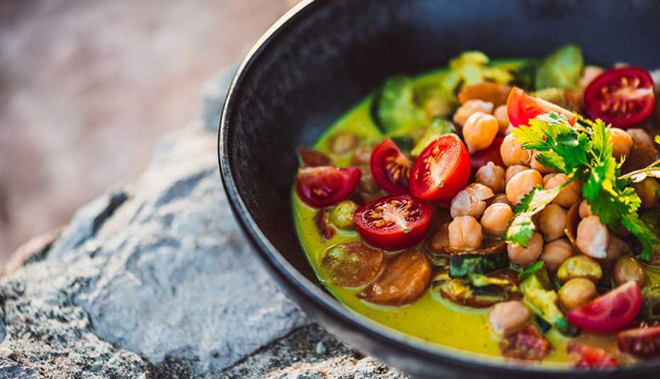A close up of Asian green curry with coconut milk in a pan
