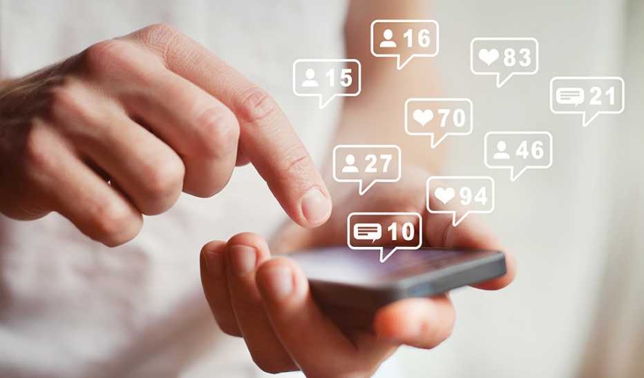 A person using a smartphone with graphics of several notification icons floating above it