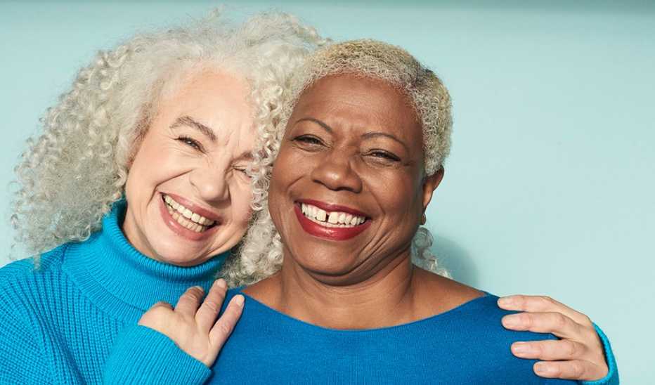 Two women standing closely and smiling together