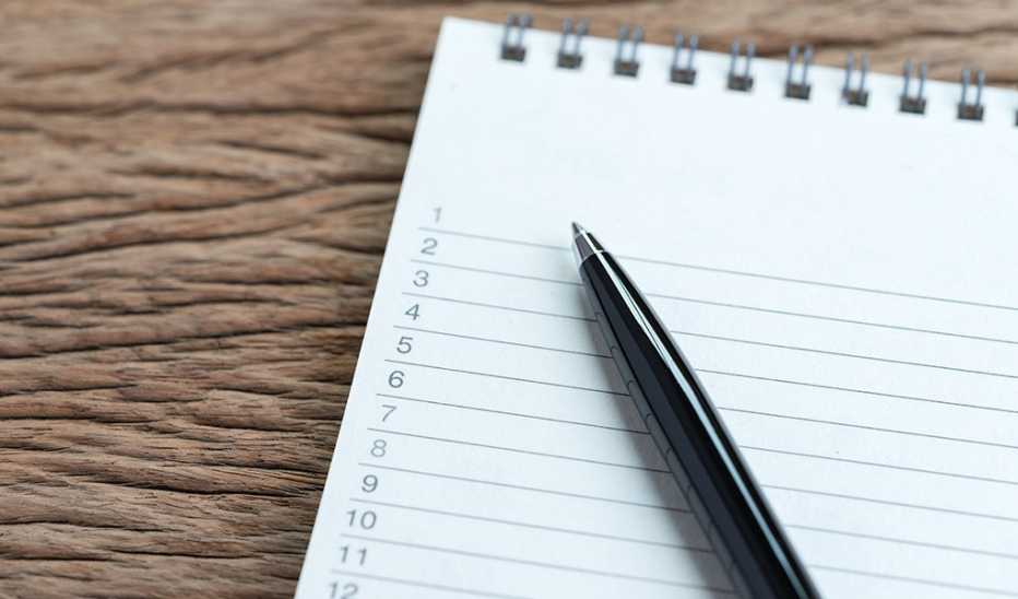 A pen on a notepad that has a listed number on each row