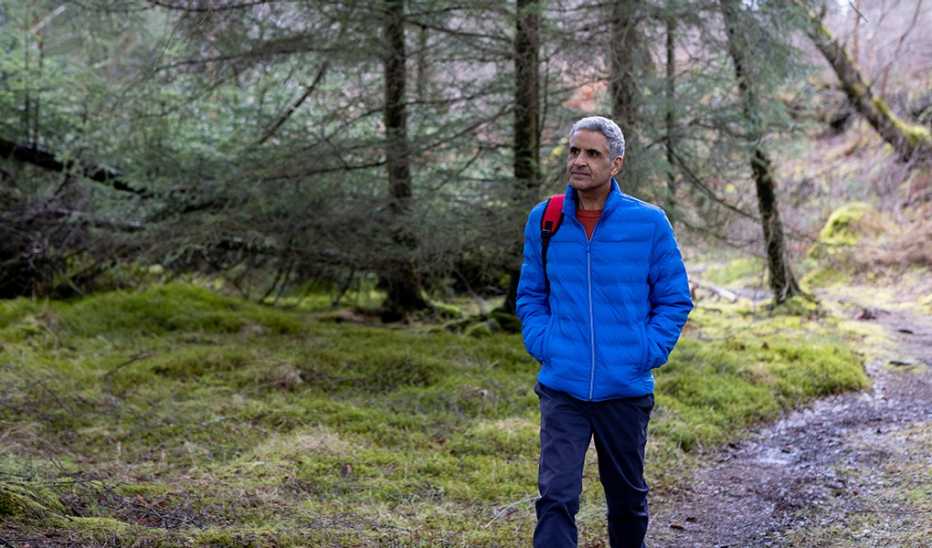 A man walking through a wooded area