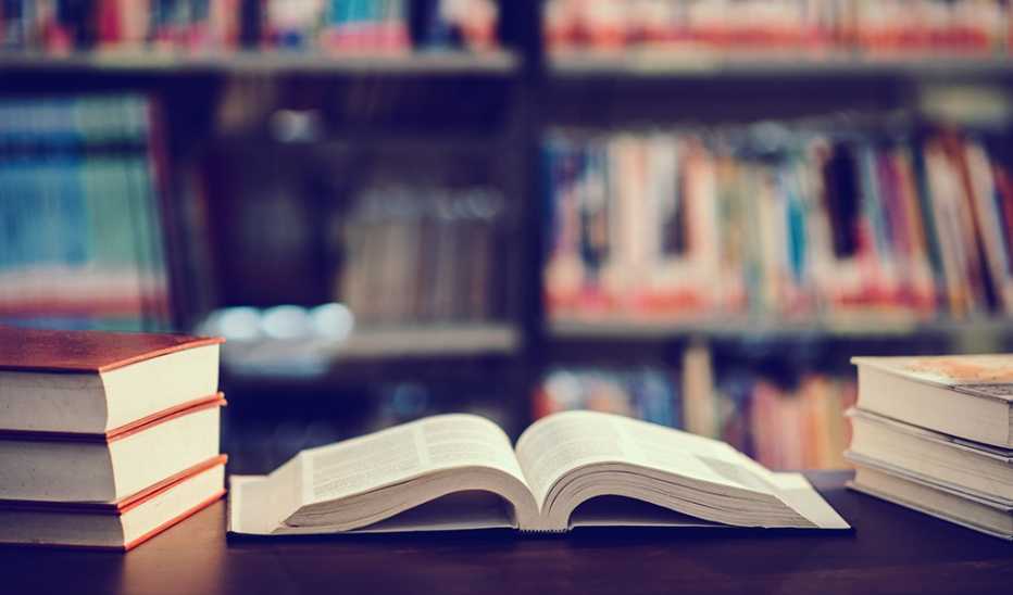 An open book on a table in a library