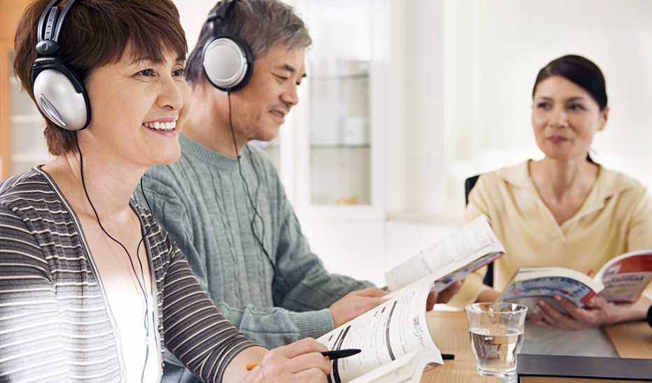 A man and woman listening to something with headphones