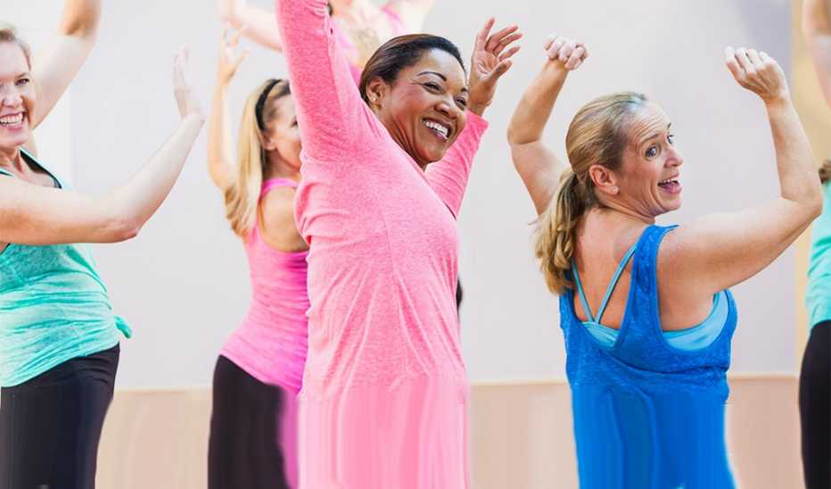 A group of women having fun taking an exercise class