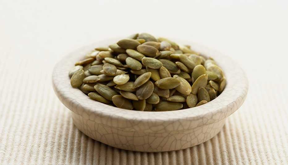 A close-up view of pepita seeds in a bowl