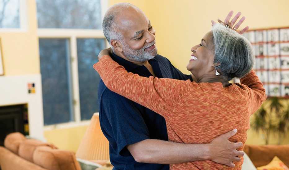 A man and woman dancing together in a home
