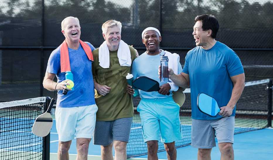 Four men smiling after playing pickleball together