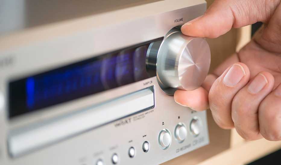 An up-close view of a hand during the dial on a radio