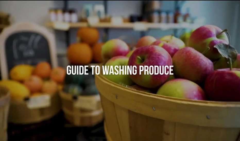 Various types of fruits in baskets with the text "guide to washing produce"