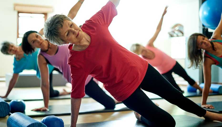 Women doing a side plank workout in a Pilates class