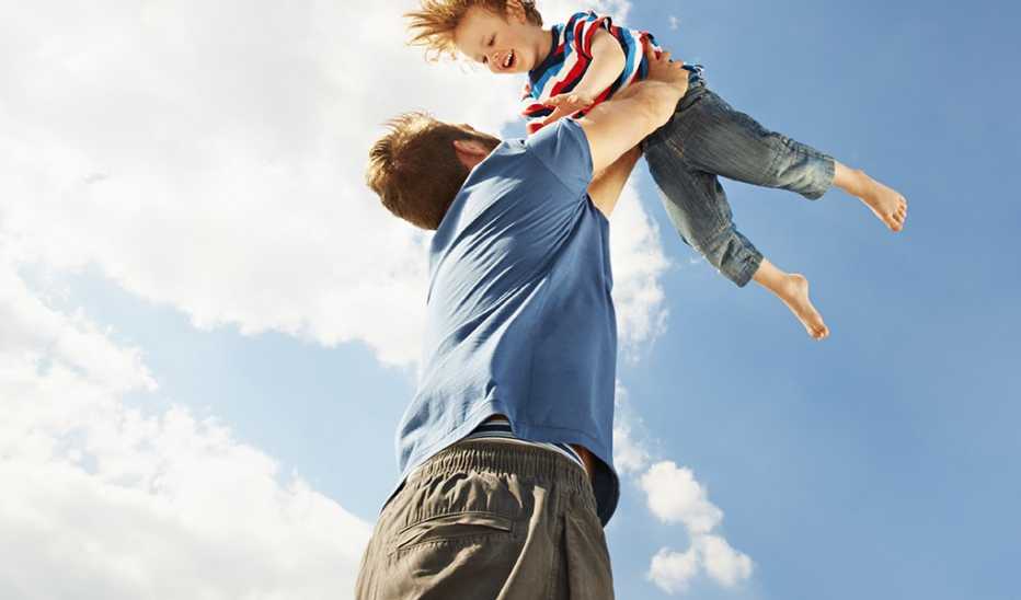 A man lifting a boy up in the air