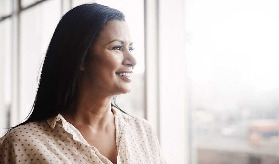 A woman looking out the window of a building