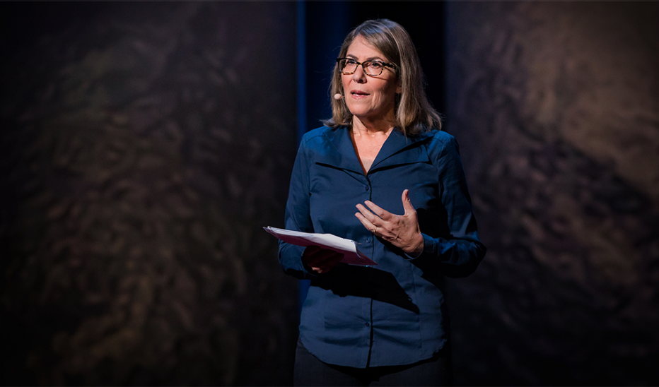 A woman, Elizabeth Lesser, speaking on stage at TED Women 2016
