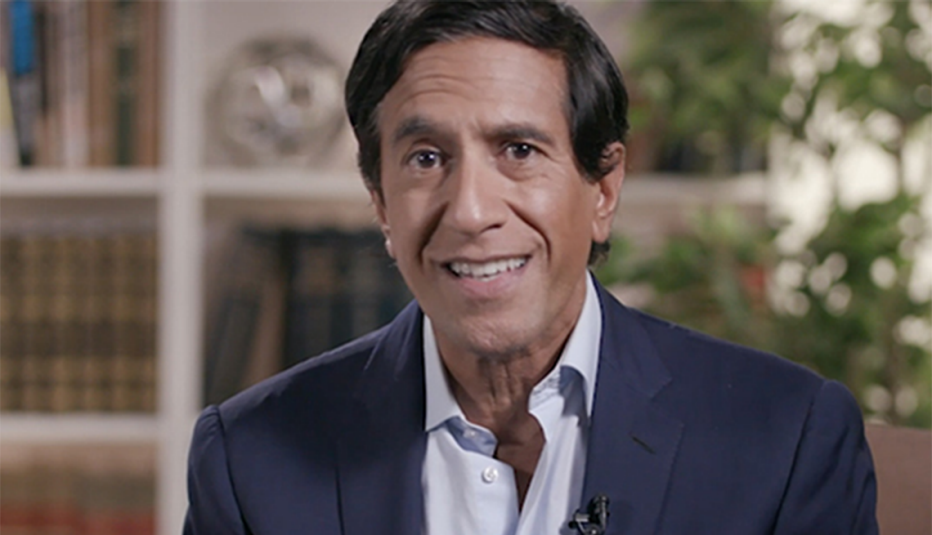 Sanjay Gupta, M.D. smiling in front of a bookshelf