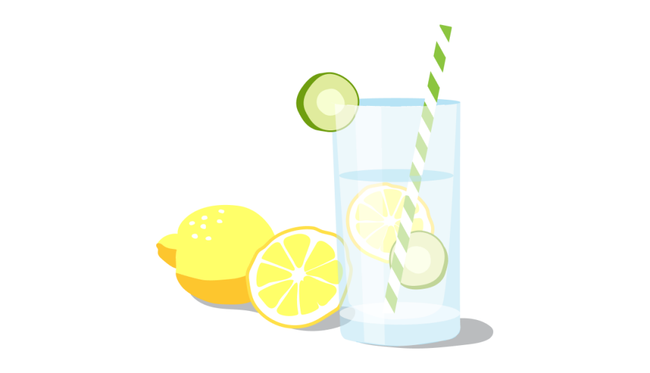 A clear glass filled with water and a straw, and two lemon halves next to it