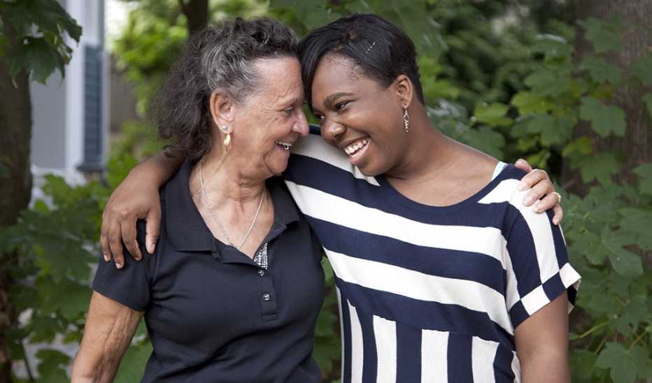 Two women smiling and hugging each other