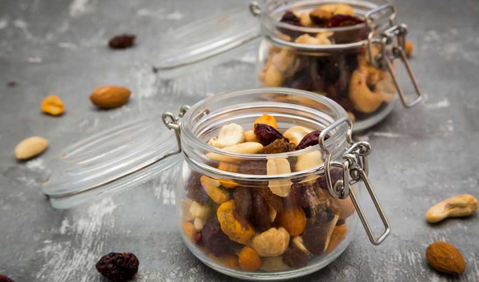A close-up view of two glasses of trail mix