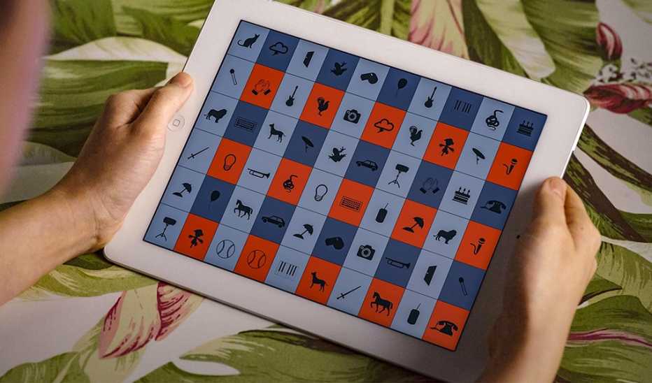 A close-up view of a tablet with icons on it in someone's hands