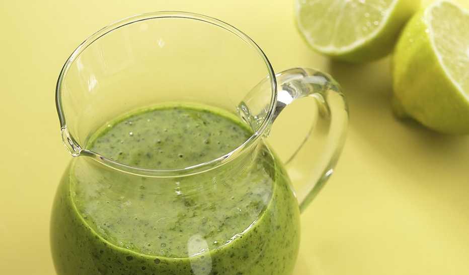 A close-up view of a pitcher of cilantro-lime vinaigrette