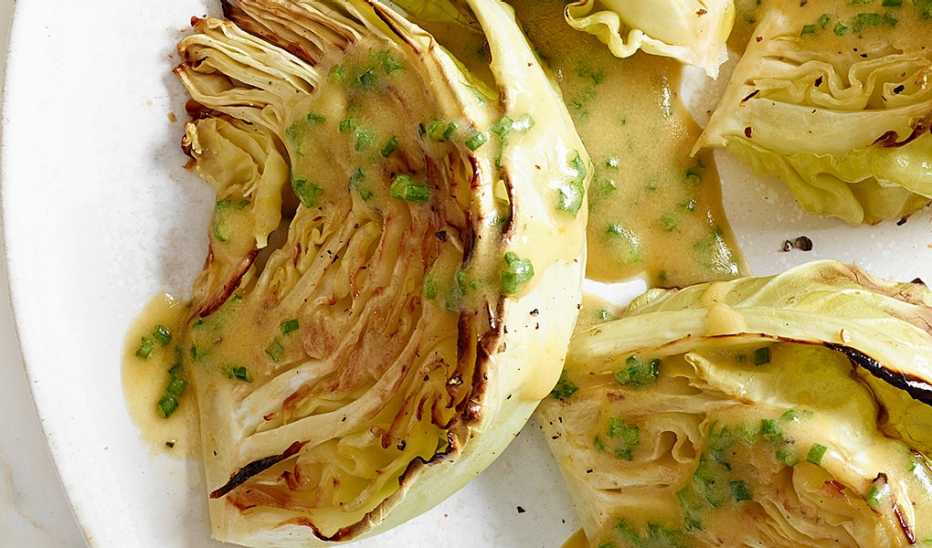 A close-up view of roasted cabbage with chive-mustard vinaigrette