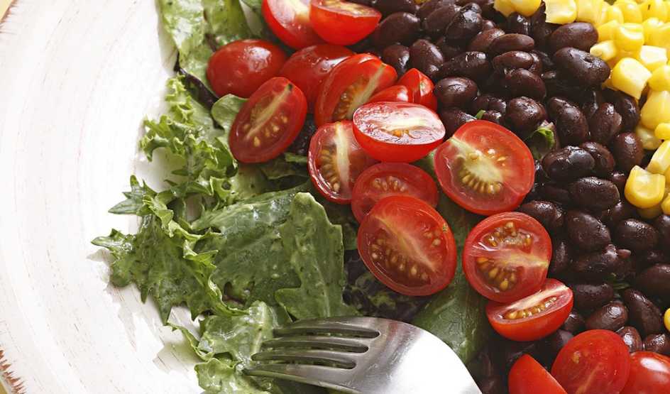 A close-up view of a southwestern salad with black beans in a plate