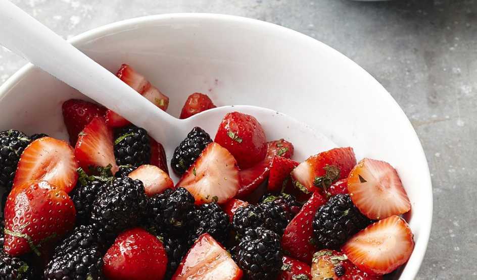 A close-up view of strawberry fruit salad in a bowl