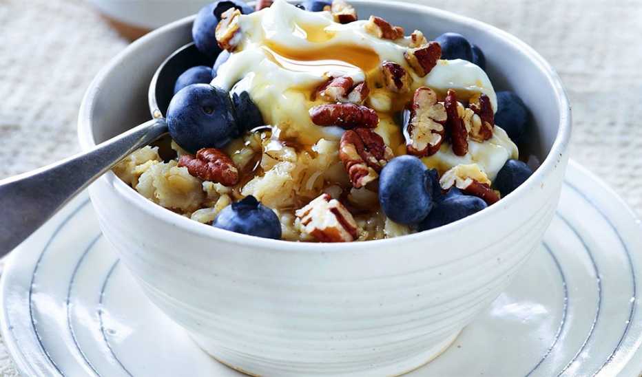A close-up view of creamy blueberry-pecan oatmeal in a bowl A close-up view of creamy blueberry-pecan oatmeal in a bowl